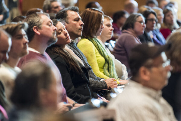 Photo of people listening at a meeting.